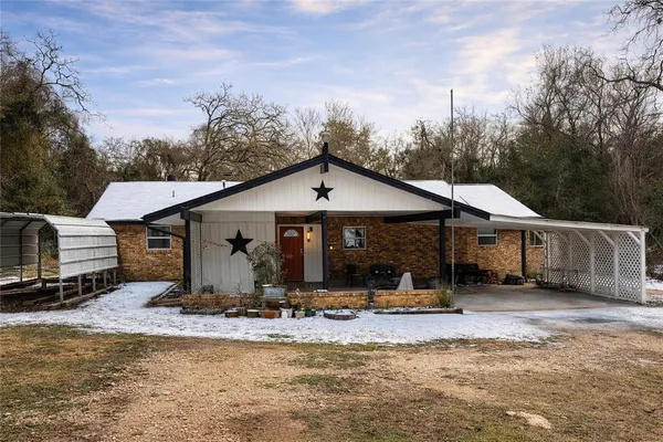 a front view of a house with a yard outdoor seating and mountain view
