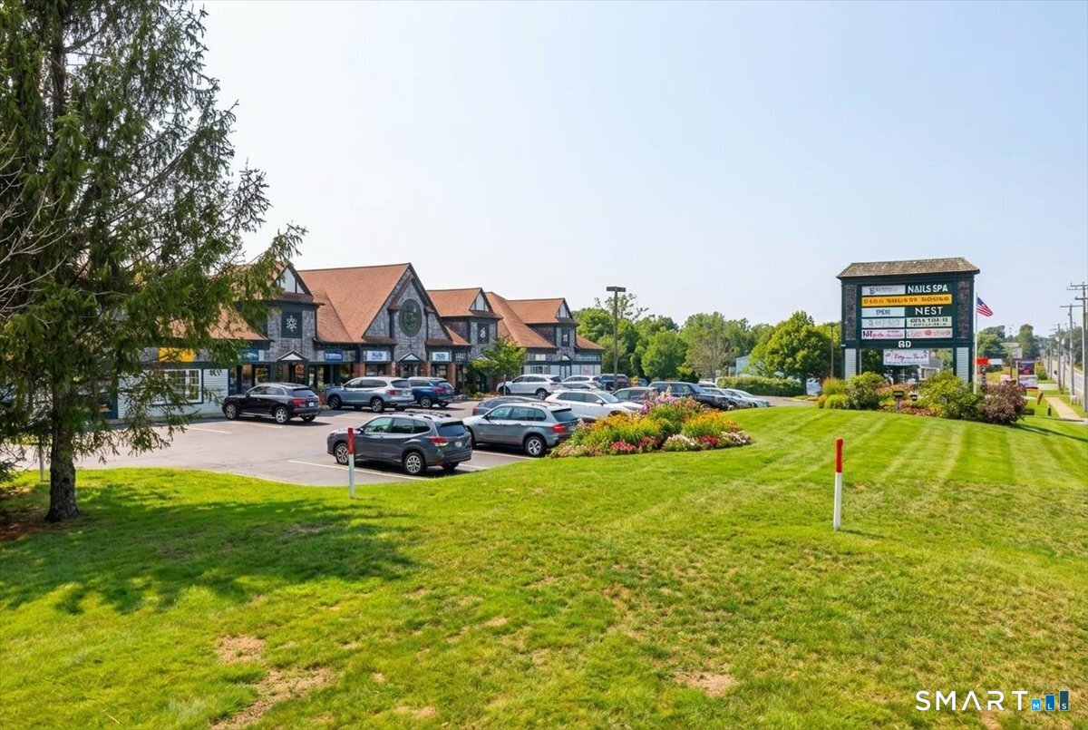 a view of a swimming pool with lawn chairs and a big yard