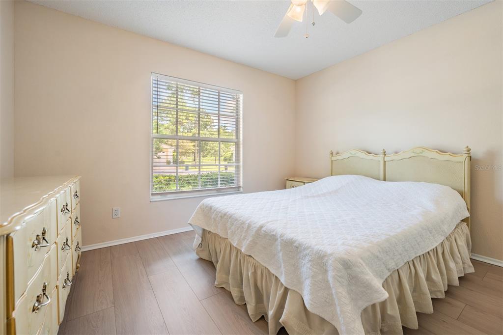 4504 Connery Court Palm Harbor, FL 34685 - Photo 16 of 33 a bedroom with a bed and a chandelier