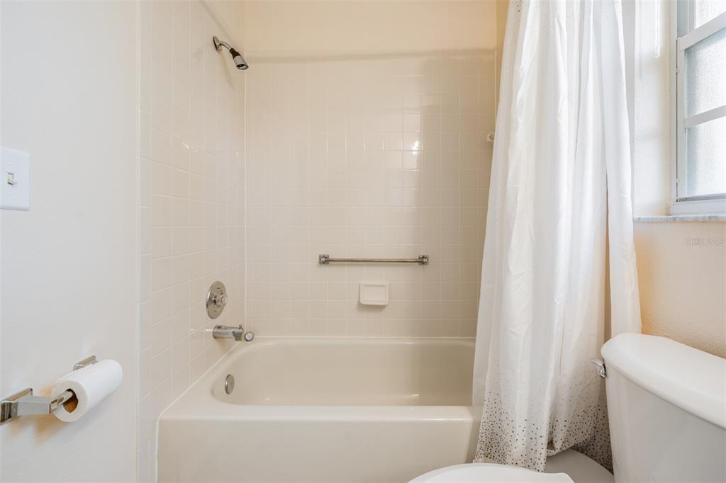 4504 Connery Court Palm Harbor, FL 34685 - Photo 18 of 33 a white bath tub with a shower curtain