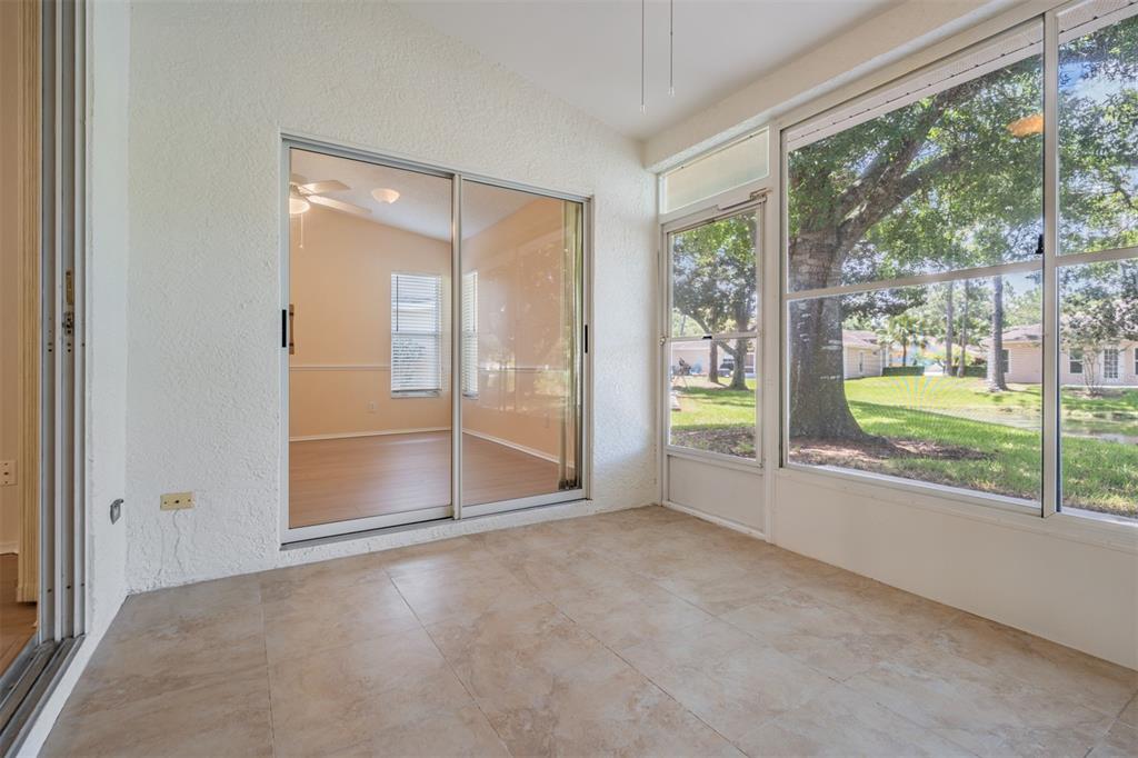 4504 Connery Court Palm Harbor, FL 34685 - Photo 21 of 33 en empty room with sliding glass door and mountain view