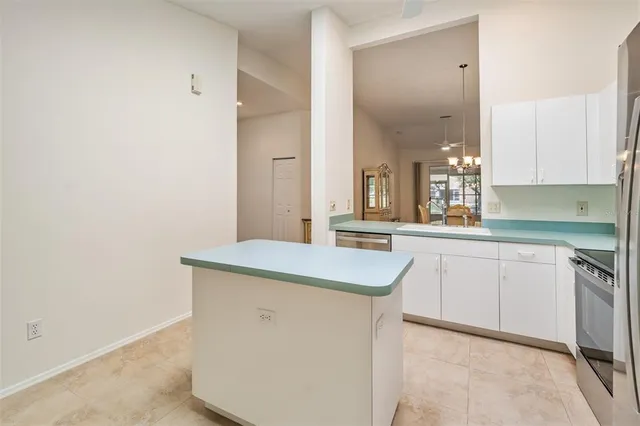 a kitchen with granite countertop cabinets stainless steel appliances and a sink