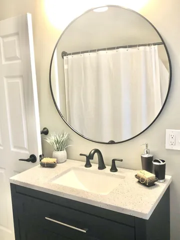 a bathroom with a sink and a mirror