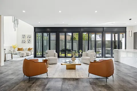 a living room with furniture and a floor to ceiling window