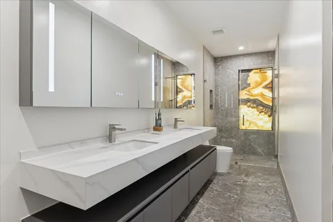 a view of a room with wooden floor and a hallway