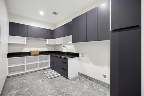 a view of a patio with table and chairs and floor to ceiling window