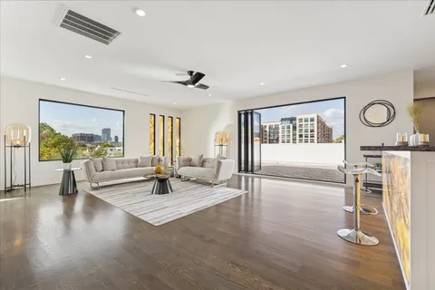 a view of a hallway with entryway wooden floor and windows