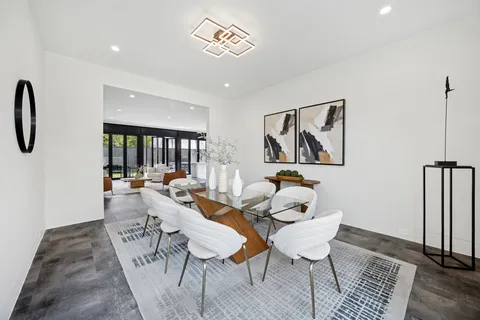 a dining room with furniture a window and wooden floor