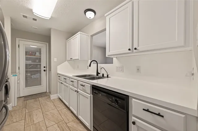 a kitchen with a sink and cabinets