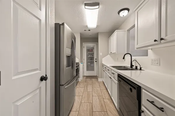 a kitchen with stainless steel appliances a sink stove and refrigerator