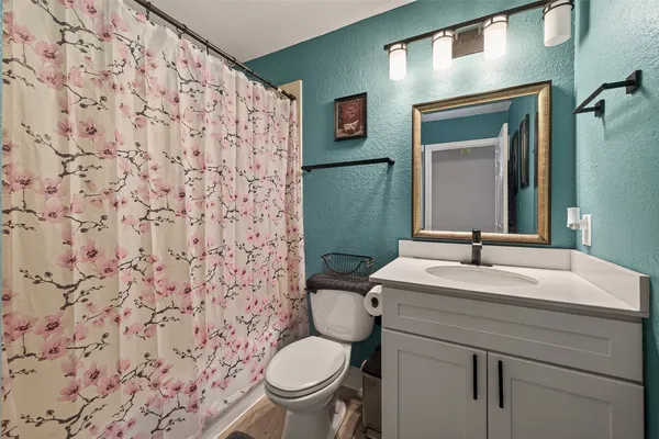 a bathroom with a sink toilet and mirror