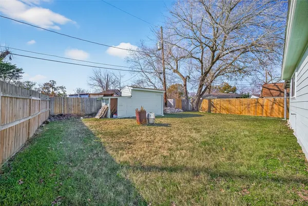 a view of a backyard with wooden fence