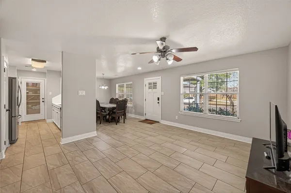 a view of livingroom with furniture a flat screen tv and staircase