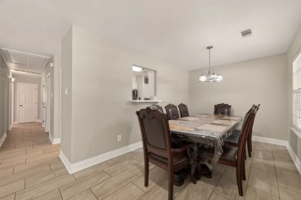 a view of a dining room with furniture and chandelier