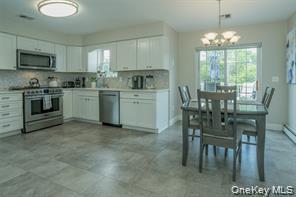7 Valley Court Florida, NY 10921 - Photo 6 of 30 a kitchen with microwave a stove and dining table