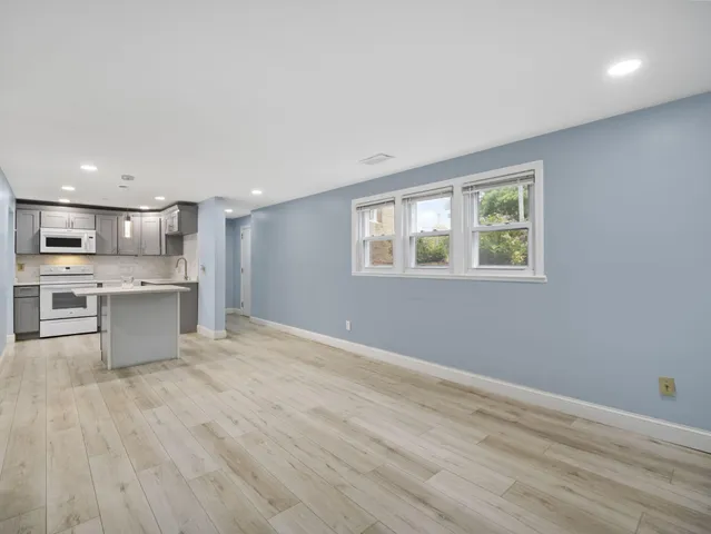 a view of kitchen with wooden floor and window
