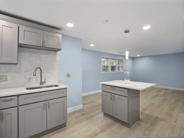 a kitchen with a sink and cabinets