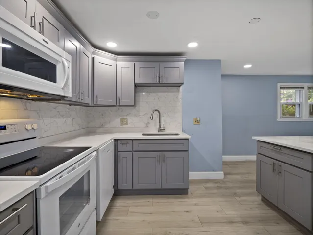 a kitchen with a sink cabinets and stainless steel appliances