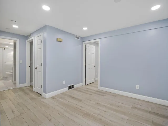 a view of hallway with wooden floor