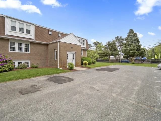 a view of a house with a yard and pathway