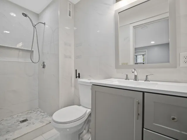 a bathroom with a sink toilet and shower