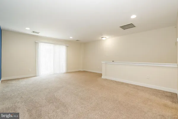 an empty room with a ceiling fan