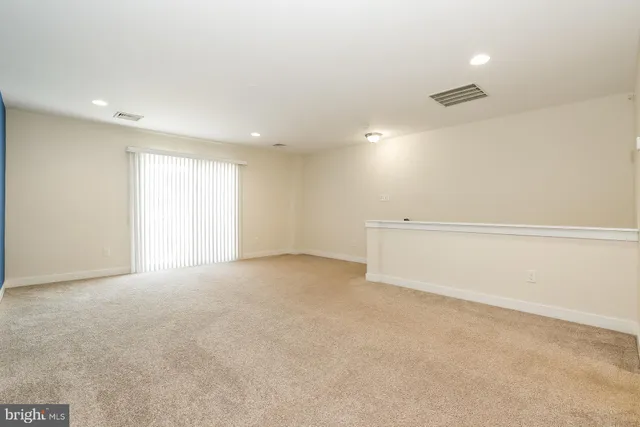 an empty room with a ceiling fan