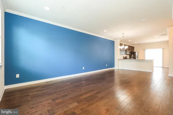 a view of a kitchen with a dishwasher and wooden floor