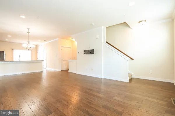 a view of a kitchen with a sink and a refrigerator