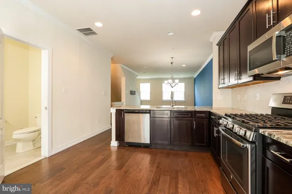 a kitchen with granite countertop a stove and a refrigerator