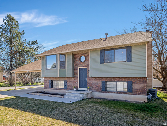 22 East 525 North Layton, UT 84041 - Photo 1 of 1 Split foyer home with a front yard, a chimney, brick siding, and roof with shingles
