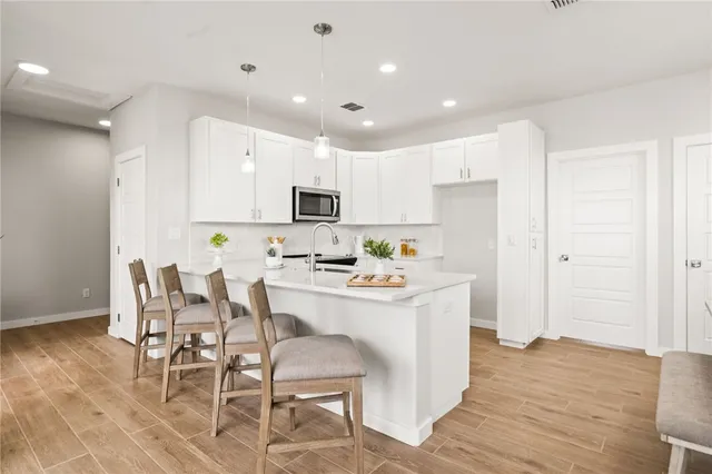 a kitchen with a sink stove and cabinets