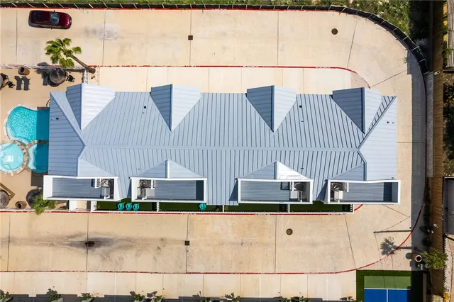 an aerial view of residential building with parking space