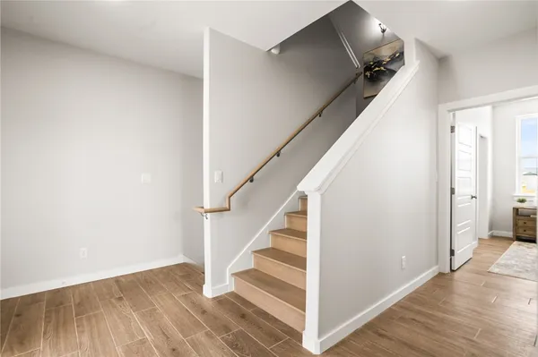 a view of a workspace room with furniture and wooden floor