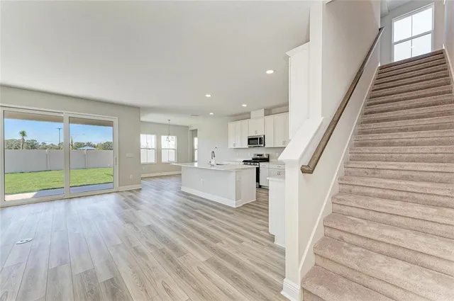 a view of entryway and hall with wooden floor