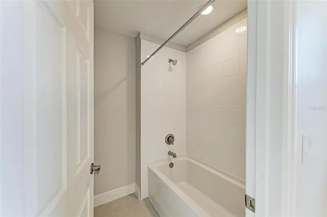 a bathroom with a bathtub and shower