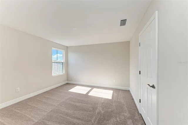 a view of an empty room and window
