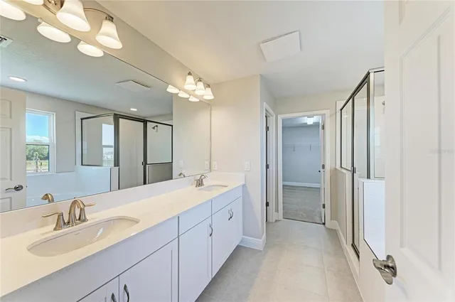 a spacious bathroom with a double vanity sink mirror and double