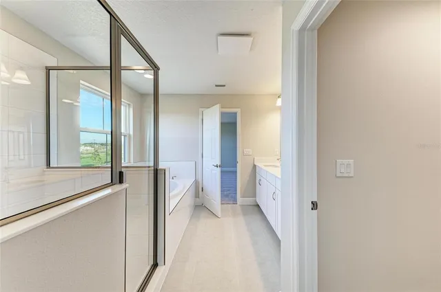 a view of a bathroom with a sink and mirror