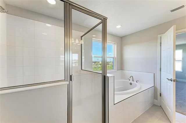 a bathroom with a tub and shower
