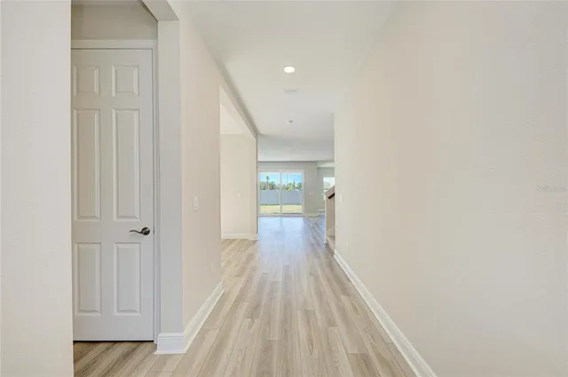 a view of a hallway with wooden floor