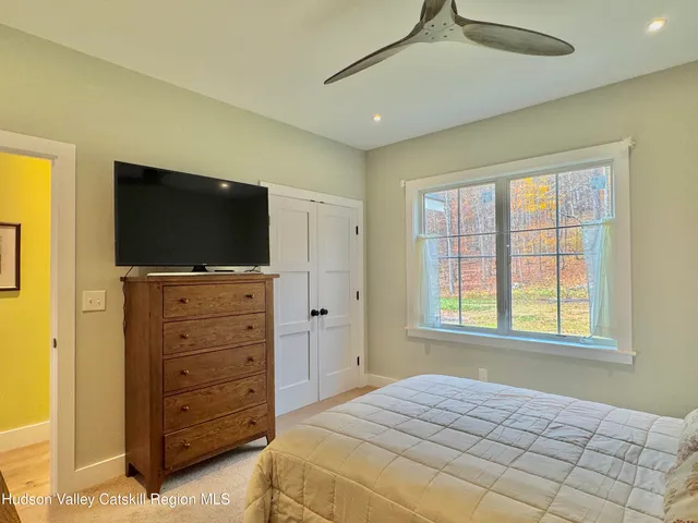 a bedroom with a bed and a flat screen tv