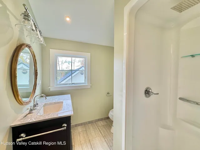 a bathroom with a toilet a sink and a mirror