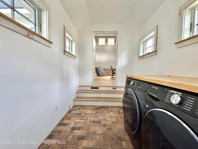 a kitchen with a refrigerator and white cabinets