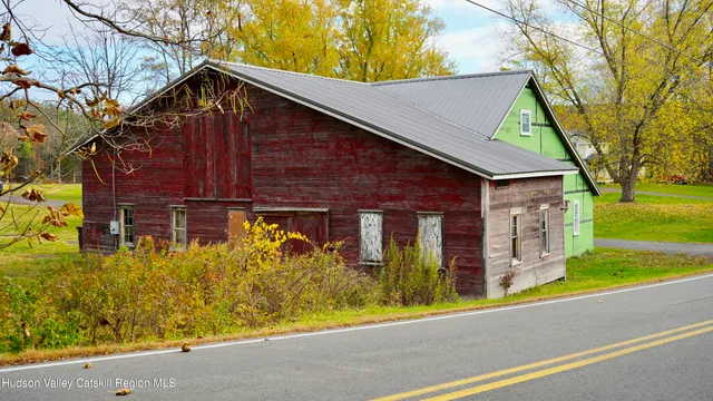 a view of a backyard with a garage and entertaining space