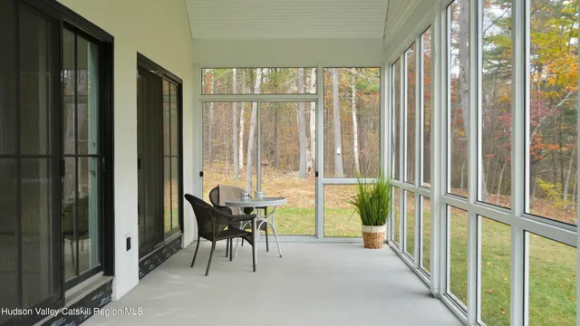 a view of a room with furniture and large windows