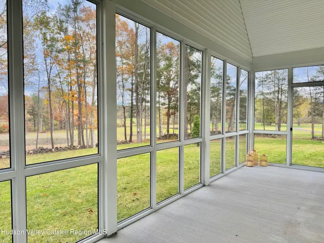 a view of porch with a floor to ceiling window and an outdoor from the room