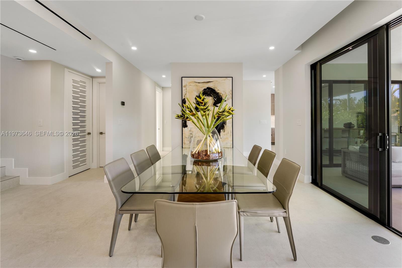 285 Woodcrest Road Key Biscayne, FL 33149 - Photo 19 of 53 a view of a dining room with furniture and wooden floor