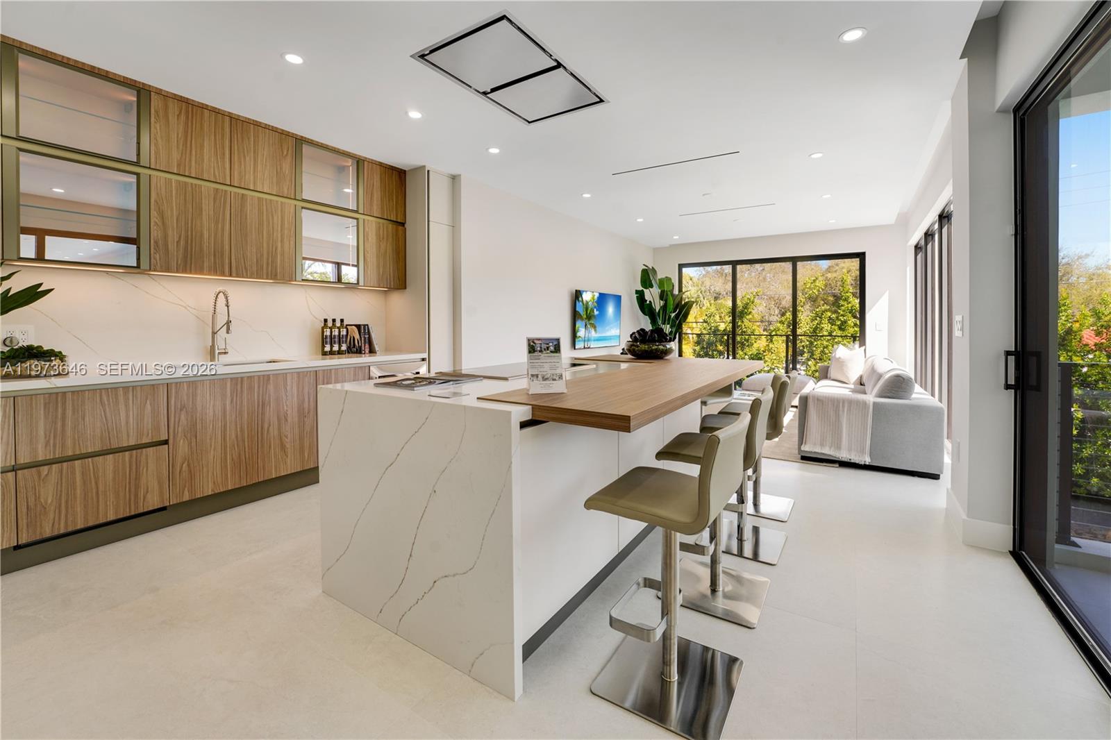 285 Woodcrest Road Key Biscayne, FL 33149 - Photo 20 of 53 a kitchen with a table chairs refrigerator and microwave