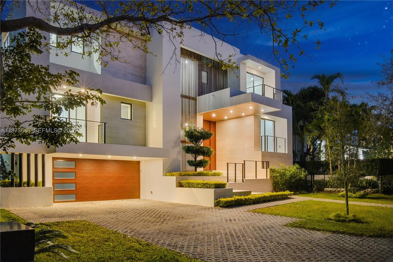 285 Woodcrest Road Key Biscayne, FL 33149 - Photo 2 of 53 a view of a building with a yard